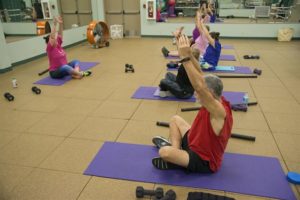 Group of people doing arm stretches