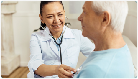 doctor using stethoscope on elderly man