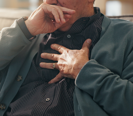 man coughing symbolizing asbestos exposure