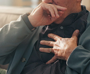 man coughing symbolizing asbestos exposure